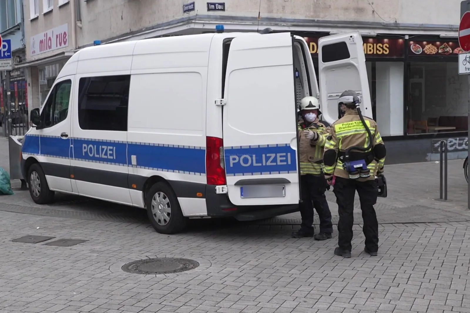 Polizeifahrzeug und Einsatzkräfte in Straßenkreuzung
