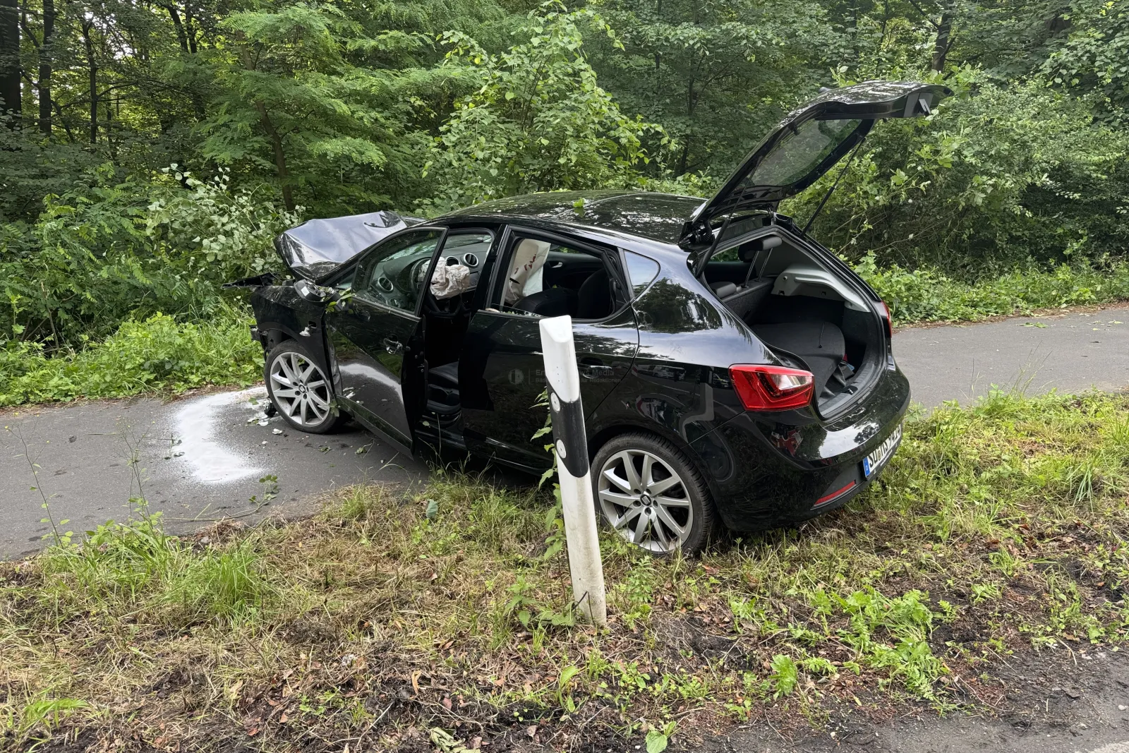 Schwarzer PKW mit schwerem Frontschaden nach Unfall gegen Baum in Brühl